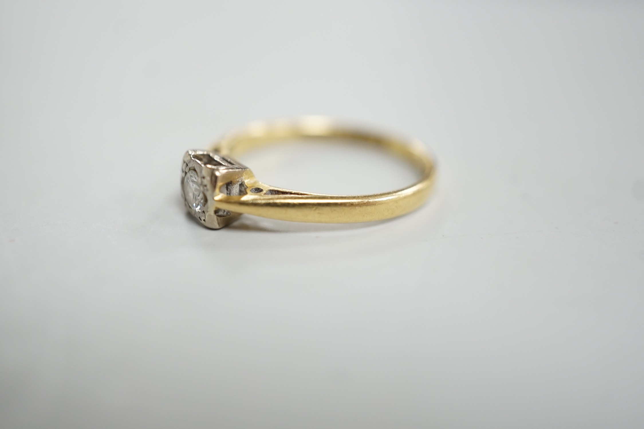 A modern 18ct gold and solitaire diamond ring, size K, gross weight 2.3 grams.